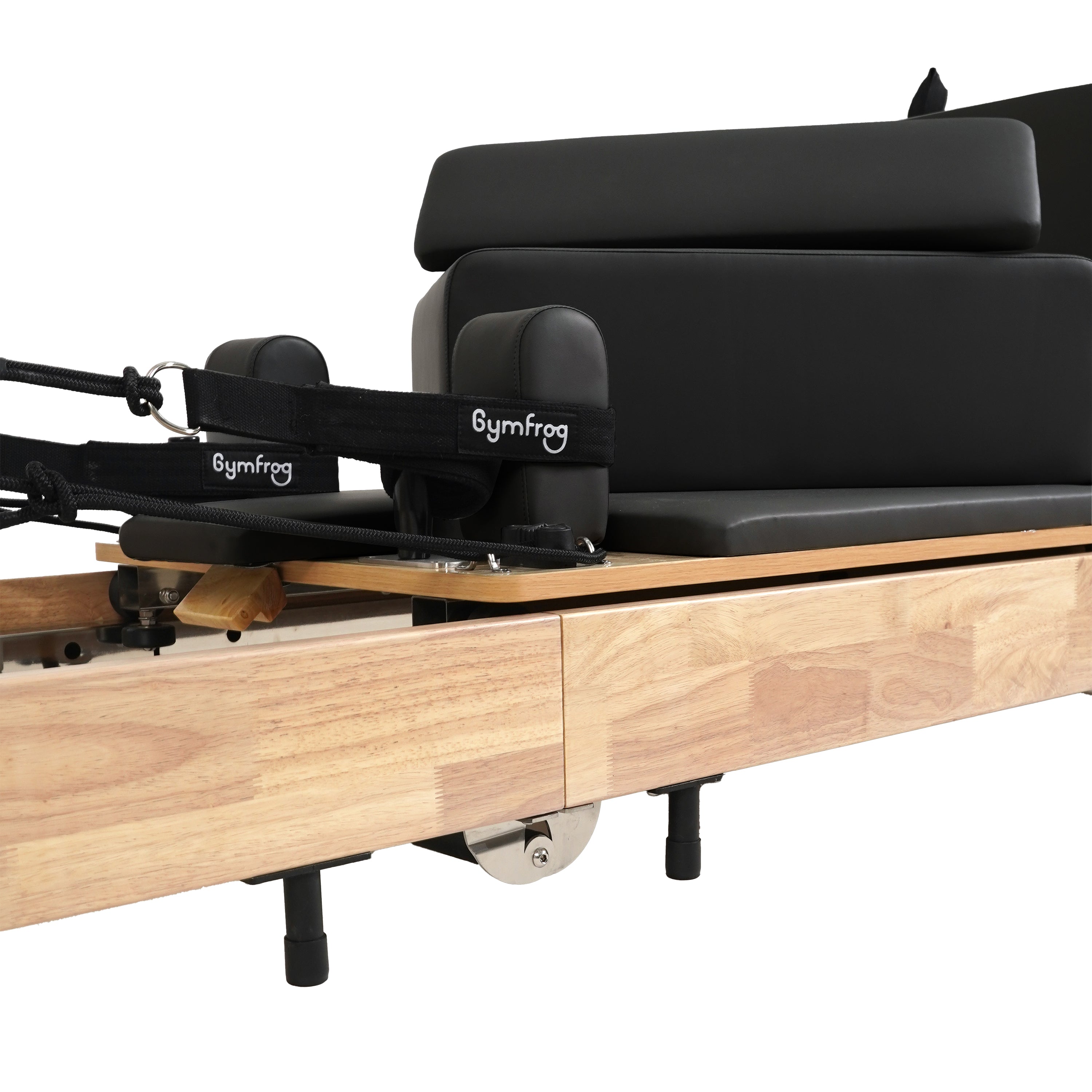 Pilates reformer with wooden frame and black cushioned seat on a white background